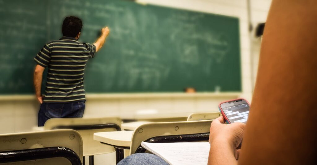 Man in Black and White Polo Shirt Beside Writing Board